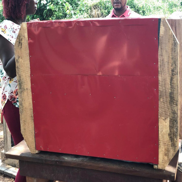 Two people looking over Some designed barriers and storage materials.