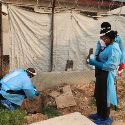 Three scientists doing field sampling of wastewater at Phebe Hospital Isolation Unit, Liberia