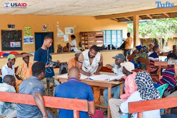 Group of community members working together in a class room on a community level simulation.