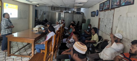 Group of students, listening to a live lecture, in small training center.